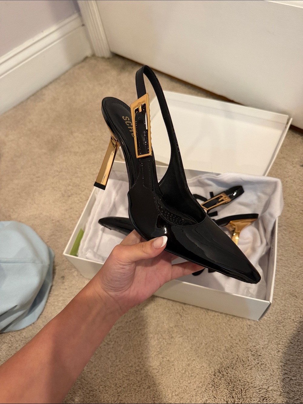 SCHUTZ Black Patent Slingback Pumps with Gold Heel Accent